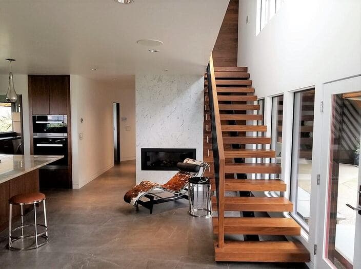 Modern Portland interior with fresh white walls and an open wood staircase