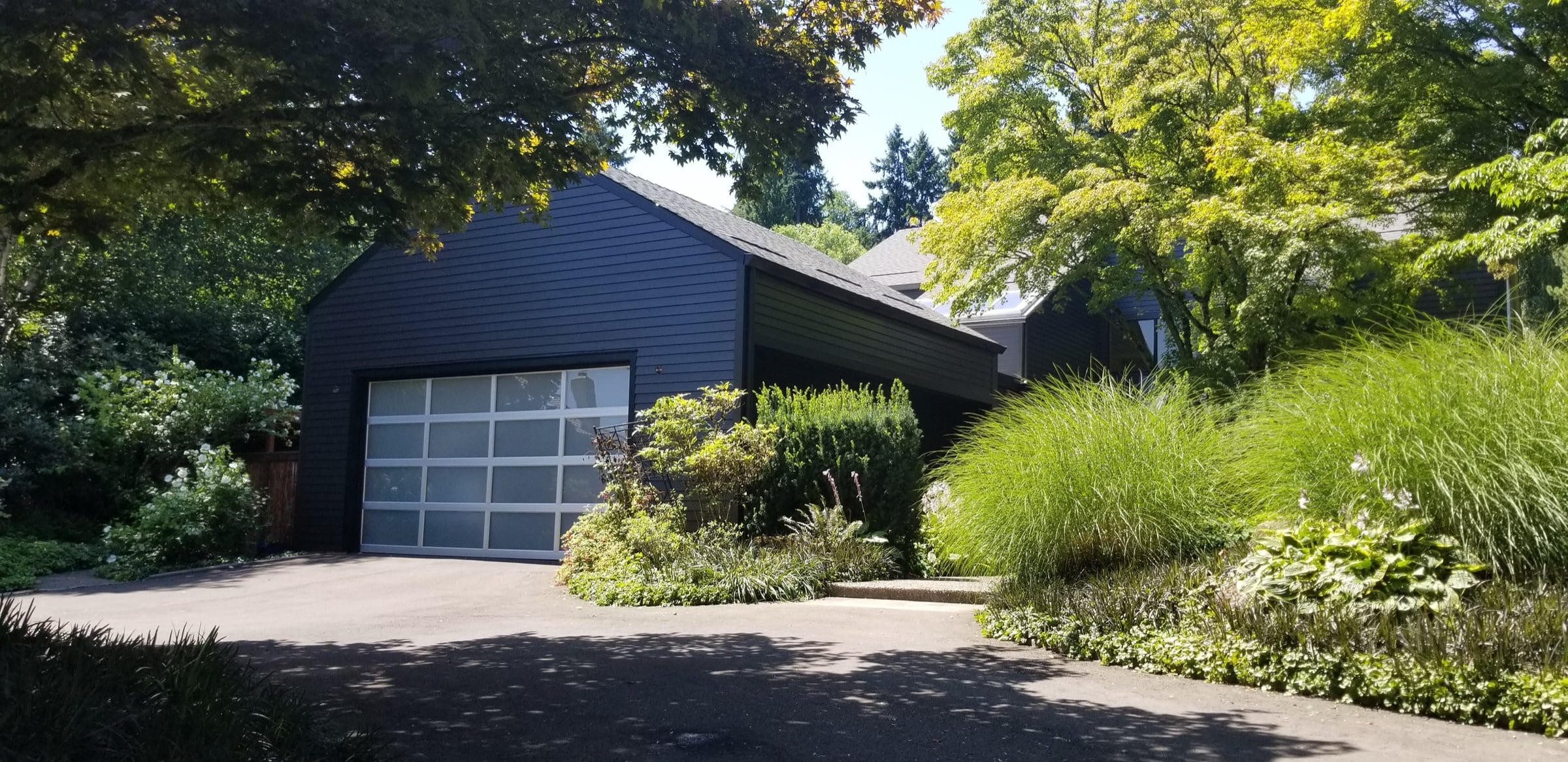 Finished exterior repaint of a timber-and-stone home