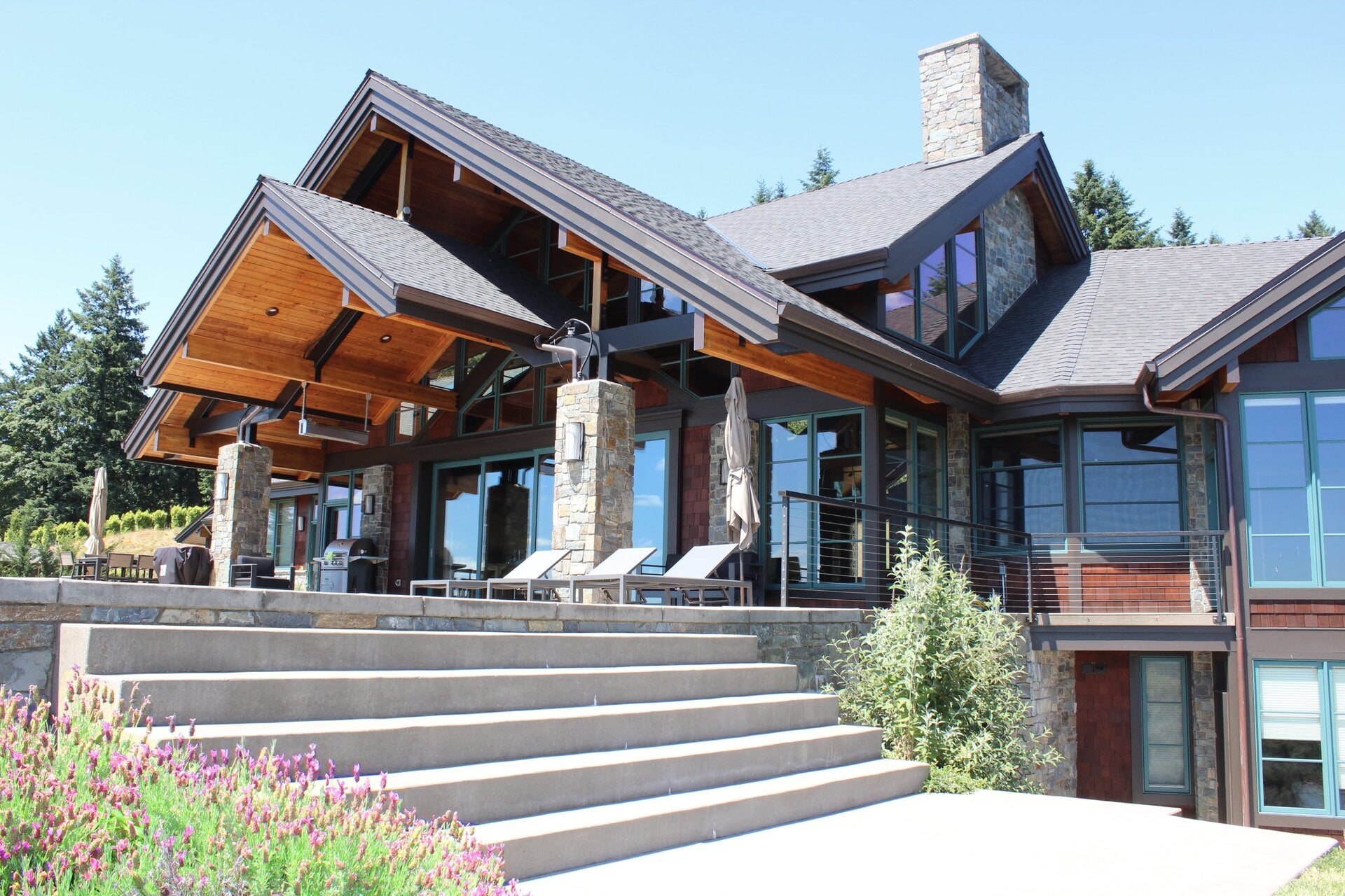 Contemporary home with stone steps and exposed wood beams